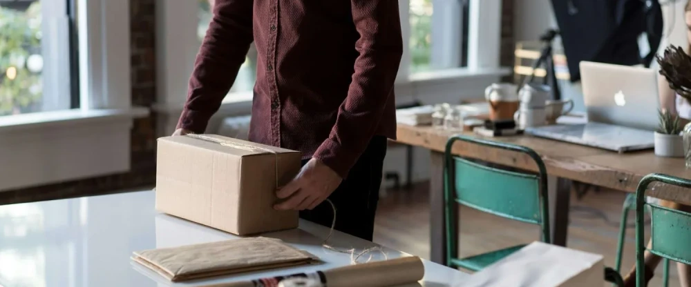 A small business owner is packing products to be shipped